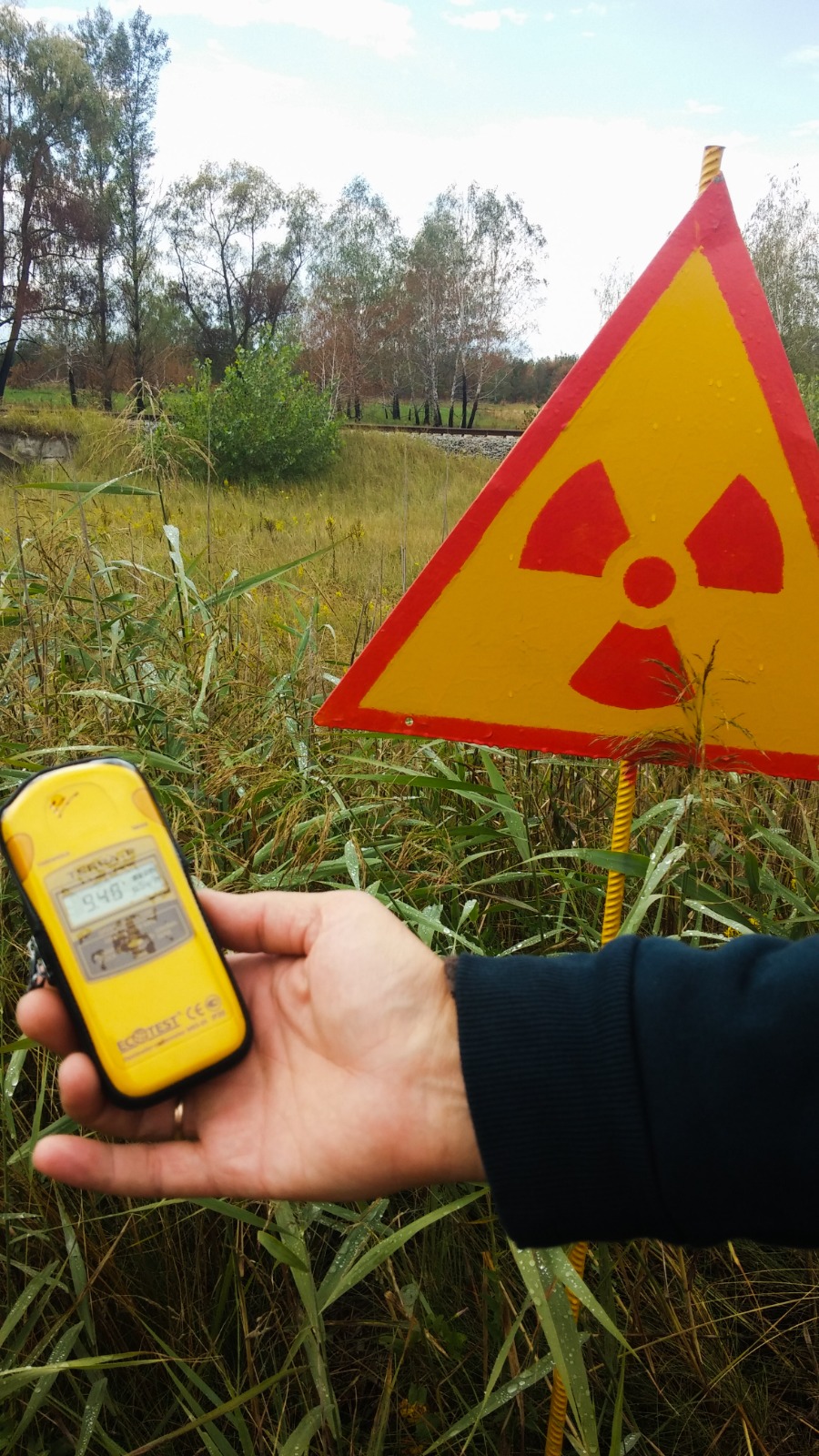 Radiation warning sign and Geiger counter near Chernobyl, Ukraine
